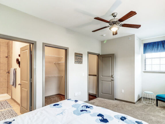 Master bedroom view with spacious closet, bathroom and window.